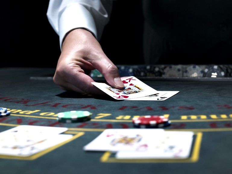 Blackjack dealer reveals his cards