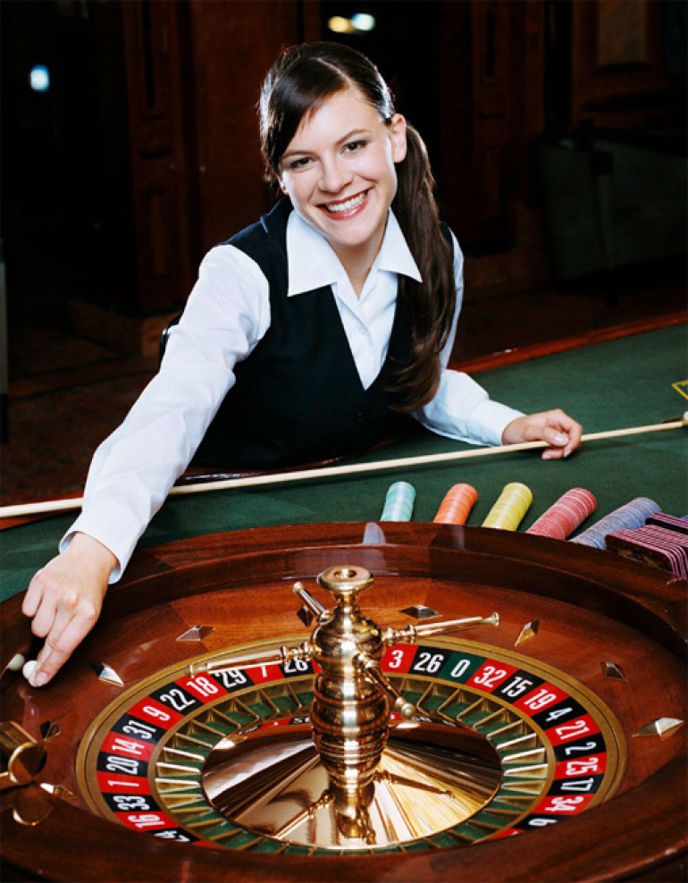  Cute girl smiling dealer, runs the ball on a roulette 
