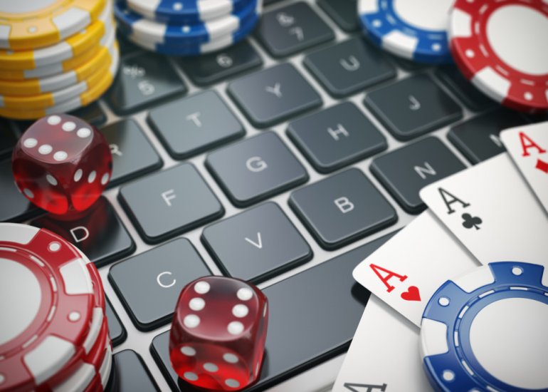 casino chips and cards on the laptop