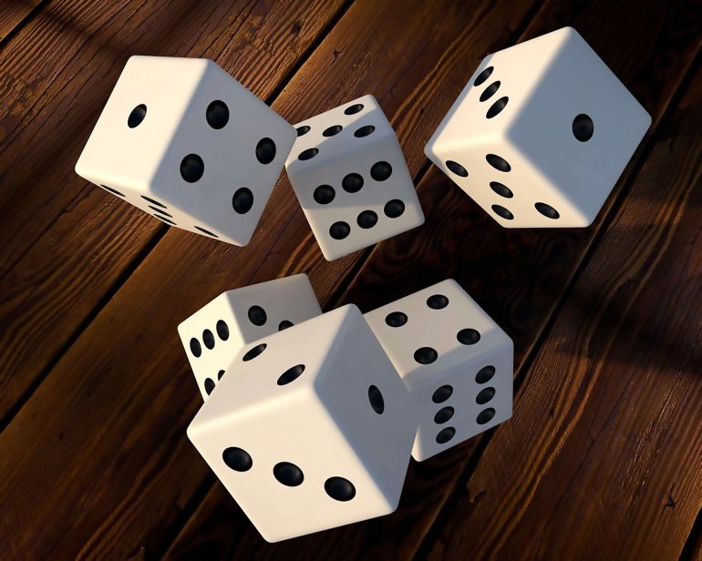 Multiple white dice in front of the wooden background