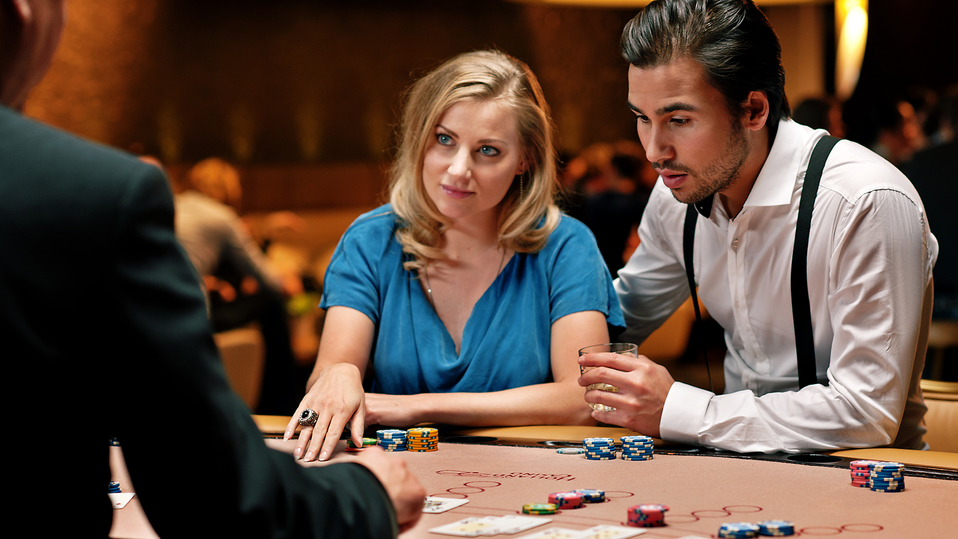 A man and a woman play blackjack in a casino The girl enthusiastically listens to the rules of the blackjack game